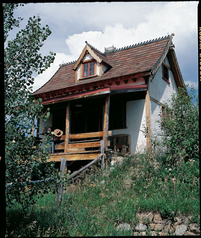 Rolland and Betty’s two-room cabin built from trees killed in the fire allows for a living area downstairs and a sleeping area upstairs. Rolland spent two years perfecting the metal scalloping on the roof, which is made from salvaged tiles.